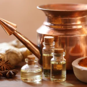 Traditional Ayurvedic oils and copper vessels for healing rituals.