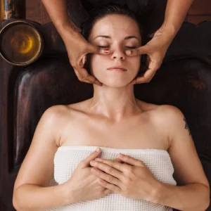 Woman receiving a relaxing facial massage at a spa.