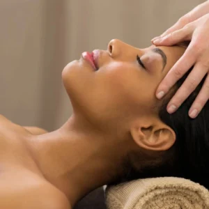 Woman receiving a relaxing head massage at a spa.