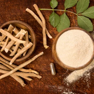 Ashwagandha roots, powder, and capsule on a rustic wooden surface.