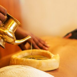 A person pouring warm oil for a relaxing massage.