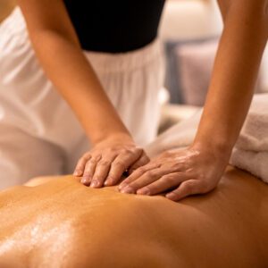 Therapist giving a relaxing back massage.