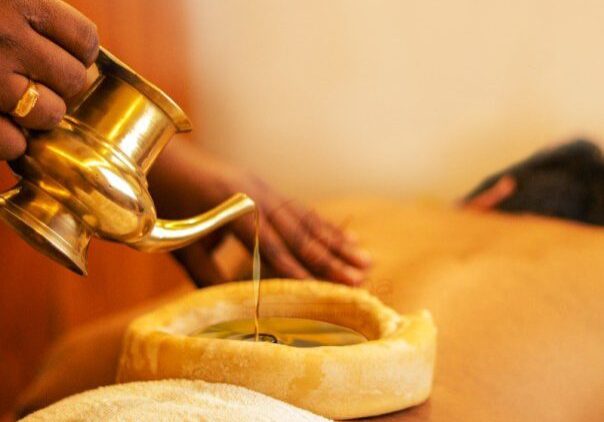 Therapeutic oil being poured for a relaxing massage.