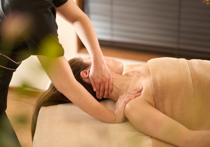 Therapist giving a relaxing shoulder massage to a client.