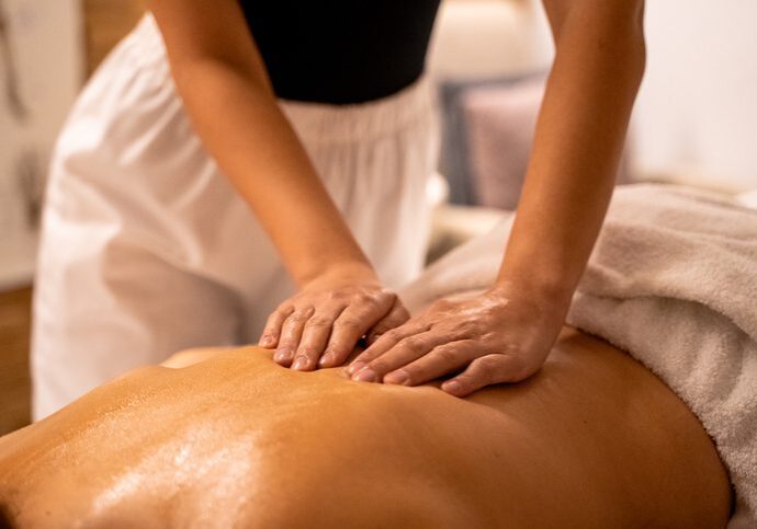 Therapist giving a relaxing back massage.