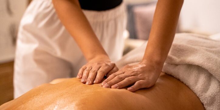 Therapist giving a relaxing back massage.