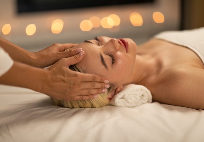 A person receiving a relaxing head massage in a calm setting.