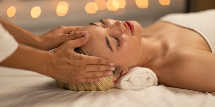 A person receiving a relaxing head massage in a calm setting.